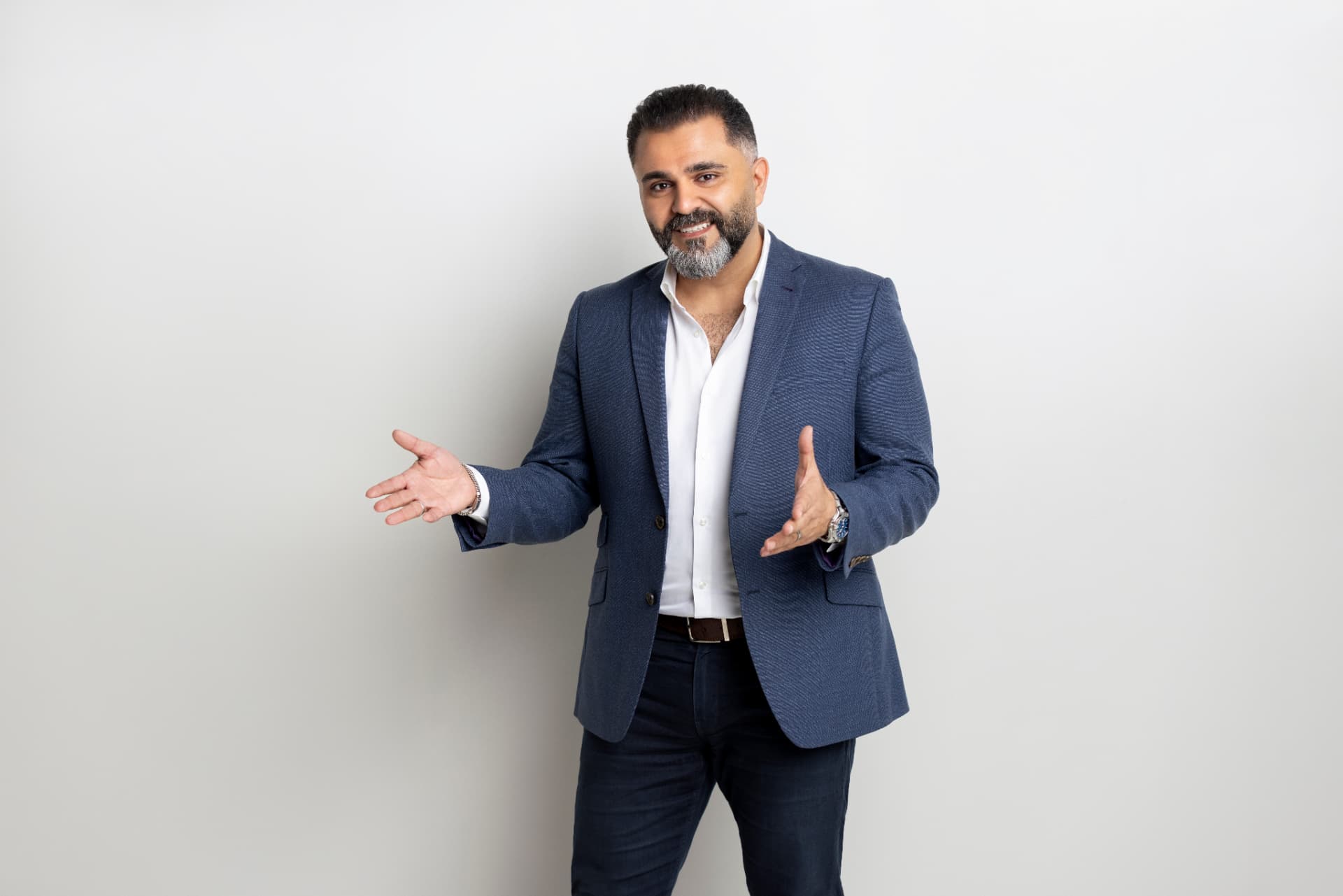Alaa Hassan presenting with open hands, mid-conversation
